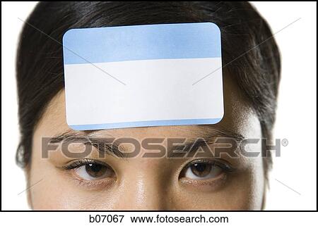 Stock Photo - Woman with ID tag on forehead. Fotosearch