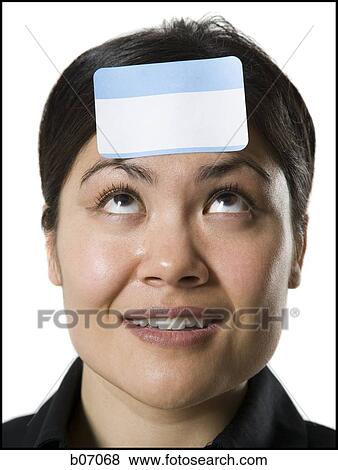 Woman with ID tag on forehead View Large Photo Image Stock Photo - Woman with ID tag on forehead. Fotosearch