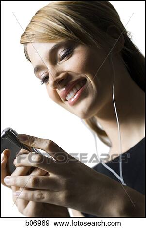 Woman with listening device and earbuds View Large Photo Image Stock Photo - Woman with listening device and earbuds. Fotosearch