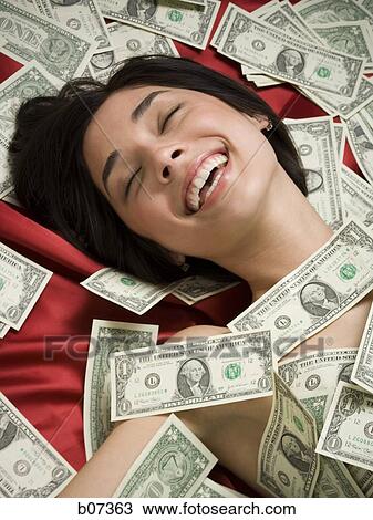 Woman with scattered dollar bills View Large Photo Image Stock Image - Woman with scattered dollar bills. Fotosearch