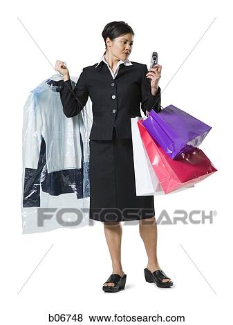 Woman with shopping bags and cellphone View Large Photo Image Stock Photo - Woman with shopping bags and cellphone. Fotosearch