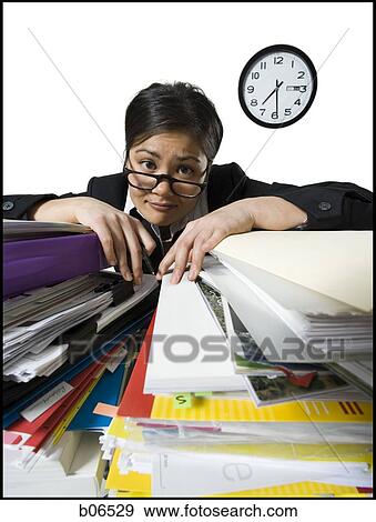 Woman with stack of binders and paperwork View Large Photo Image Stock Photo - Woman with stack of binders and paperwork. Fotosearch