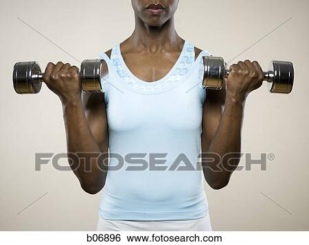 Woman working with dumbells View Large Photo Image Stock Photograph - Woman working with dumbells. Fotosearch