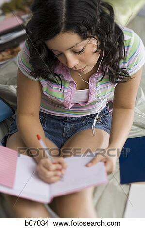 Woman writing in notebook View Large Photo Image Picture - Woman writing in notebook. Fotosearch