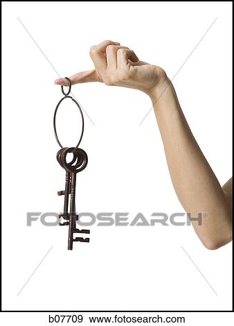 Stock Photo - Woman''s arm holding a set of skeleton keys. Fotosearch