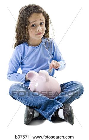Young girl depositing money in piggy bank View Large Photo Image Stock Image - Young girl depositing money in piggy bank. Fotosearch