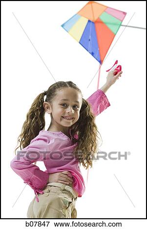 Stock Photo - Young girl flying a kite. Fotosearch