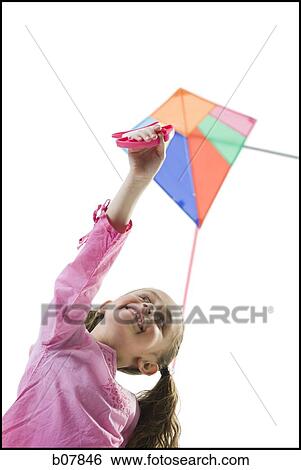 Young girl flying a kite View Large Photo Image Stock Photograph - Young girl flying a kite. Fotosearch