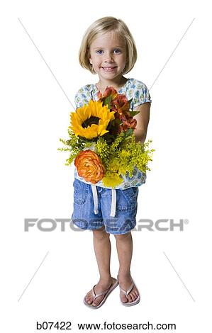Young girl holding a flower arrangement View Large Photo Image Stock Image - Young girl holding a flower arrangement. Fotosearch