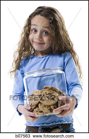 Young girl holding cookie jar View Large Photo Image Stock Image - Young girl holding cookie jar. Fotosearch