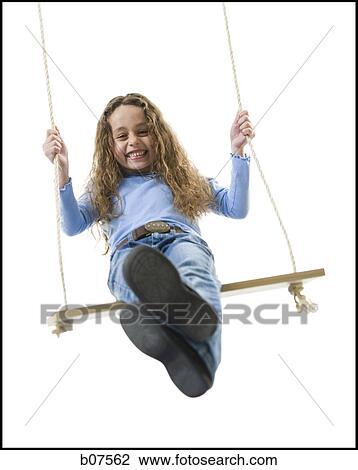 Young girl playing on a swing View Large Photo Image Stock Image - Young girl playing on a swing. Fotosearch