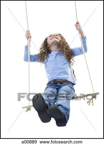Young girl playing on a swing View Large Photo Image Stock Photo - Young girl playing on a swing. Fotosearch