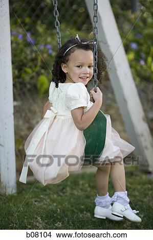 Young girl playing on swing View Large Photo Image Picture - Young girl playing on swing. Fotosearch