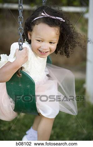 Young girl playing on swing View Large Photo Image Stock Image - Young girl playing on swing. Fotosearch