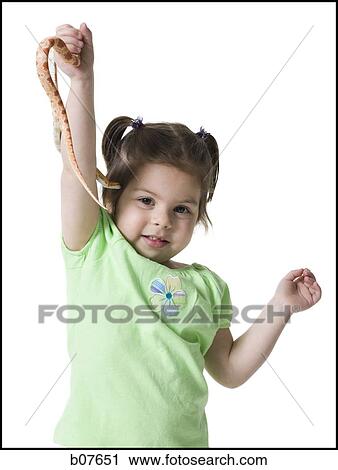 Young girl playing with a snake View Large Photo Image Stock Image - Young girl playing with a snake. Fotosearch