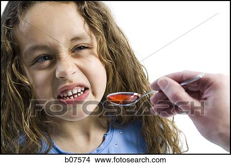 Young girl taking a spoonful of medicine View Large Photo Image Picture - Young girl taking a spoonful of medicine. Fotosearch