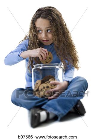 Young girl taking cookie from cookie jar View Large Photo Image Stock Photograph - Young girl taking cookie from cookie jar. Fotosearch