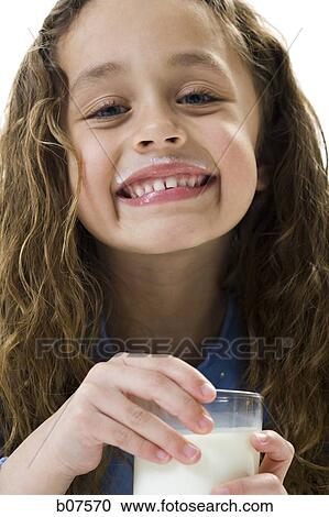 Young girl with a glass of milk View Large Photo Image Stock Image - Young girl with a glass of milk. Fotosearch