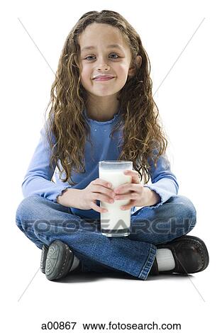 Young girl with a glass of milk View Large Photo Image Stock Photo - Young girl with a glass of milk. Fotosearch