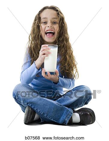 Young girl with a glass of milk View Large Photo Image Stock Photo - Young girl with a glass of milk. Fotosearch