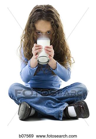 Young girl with a glass of milk View Large Photo Image Stock Photo - Young girl with a glass of milk. Fotosearch