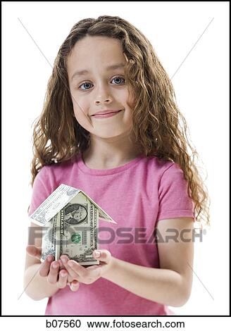 Young girl with a little house made of banknotes View Large Photo Image Stock Image - Young girl with a little house made of banknotes. Fotosearch