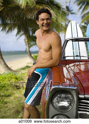 Stock Photo - Young man leaning against a car. Fotosearch