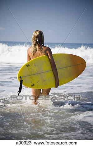 Young woman with surfboard on beach View Large Photo Image Stock Image - Young woman with surfboard on beach. Fotosearch