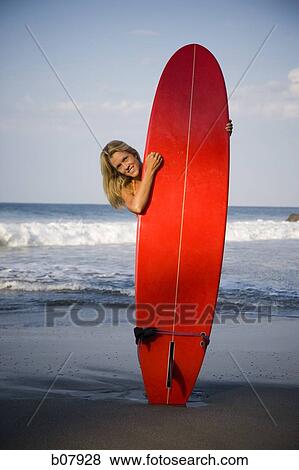 Young woman with surfboard on beach View Large Photo Image Stock Photo - Young woman with surfboard on beach. Fotosearch