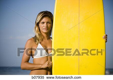 Young woman with surfboard on beach View Large Photo Image Stock Photography - Young woman with surfboard on beach. Fotosearch