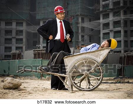 Architect on the job site with a worker. View Large Photo Image Stock Image - Architect on the job site with a worker.. Fotosearch