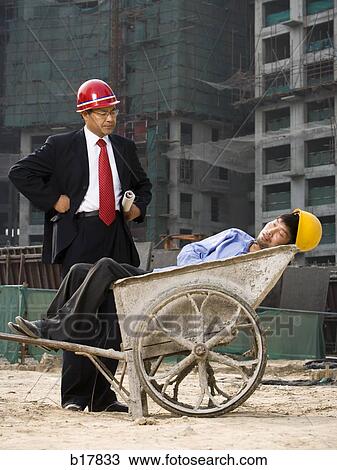 Architect on the job site with a worker. View Large Photo Image Stock Image - Architect on the job site with a worker.. Fotosearch