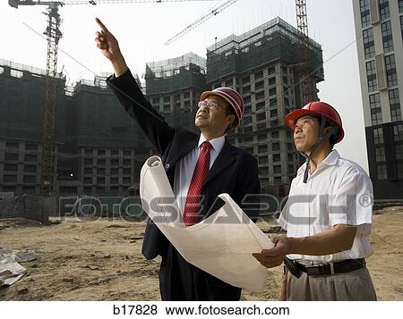 Architect on the job site with a worker. View Large Photo Image Stock Photo - Architect on the job site with a worker.. Fotosearch