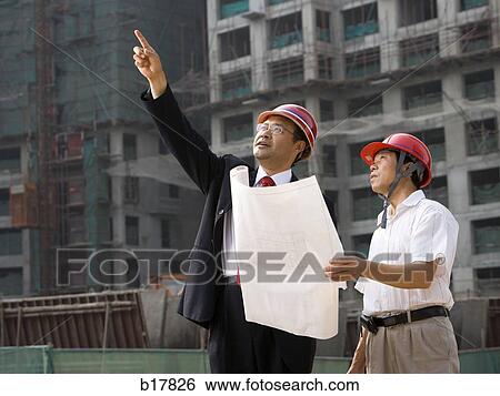Architect on the job site with a worker. View Large Photo Image Stock Photograph - Architect on the job site with a worker.. Fotosearch