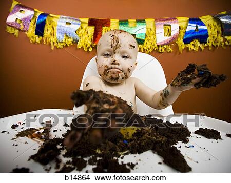 Picture - Baby eating birthday cake. Fotosearch