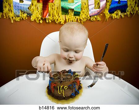 Stock Photograph - Baby eating birthday cake. Fotosearch