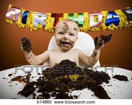 Stock Photography - Baby eating birthday cake. Fotosearch