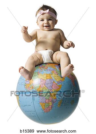 Stock Photo - Baby girl in diaper smiling and sitting on globe. Fotosearch