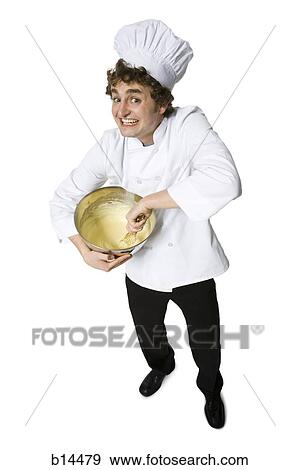 Baker with chef hat and mixing bowl smiling View Large Photo Image Stock Photo - Baker with chef hat and mixing bowl smiling. Fotosearch