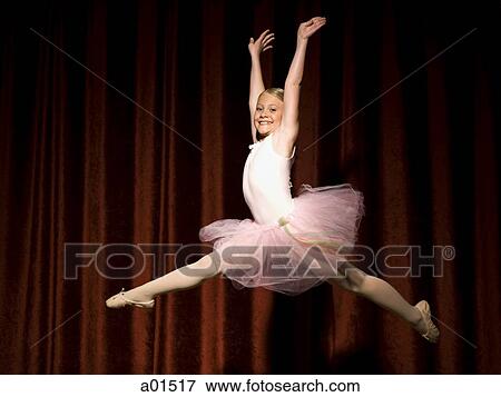Ballerina girl leaping and smiling View Large Photo Image Stock Photo - Ballerina girl leaping and smiling. Fotosearch