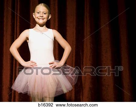 Ballerina girl on stage with hands on hips smiling View Large Photo Image Stock Image - Ballerina girl on stage with hands on hips smiling. Fotosearch
