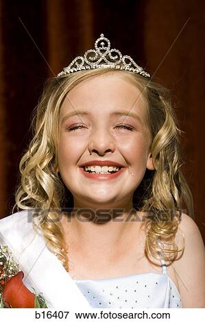 Stock Photo - Beauty pageant winner smiling and holding roses. Fotosearch