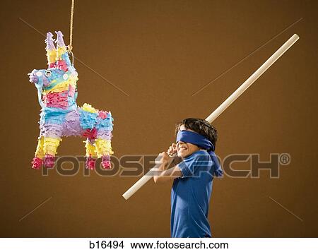 Picture - Blindfolded boy with stick and pinata. Fotosearch