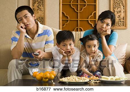 Bored family watching television View Large Photo Image Stock Photo - Bored family watching television. Fotosearch