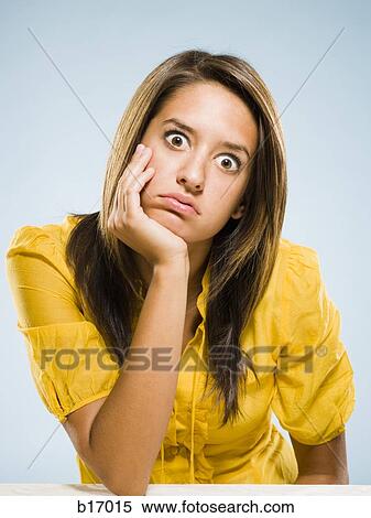 Stock Photography - Bored woman sitting and staring. Fotosearch