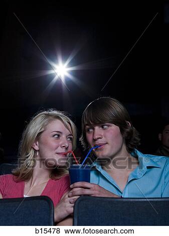 Boy and girl sharing beverage at movie theater View Large Photo Image Stock Photo - Boy and girl sharing beverage at movie theater. Fotosearch