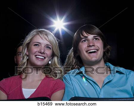 Boy and girl watching film at movie theater smiling View Large Photo Image Stock Photo - Boy and girl watching film at movie theater smiling. Fotosearch