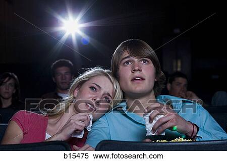 Boy and girl with tissues crying at movie theater View Large Photo Image Stock Photography - Boy and girl with tissues crying at movie theater. Fotosearch