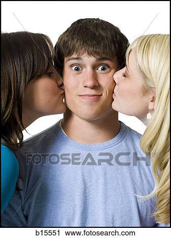 Boy being kissed on both cheeks by two girls View Large Photo Image Stock Image - Boy being kissed on both cheeks by two girls. Fotosearch