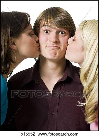 Boy being kissed on both cheeks by two girls View Large Photo Image Stock Image - Boy being kissed on both cheeks by two girls. Fotosearch